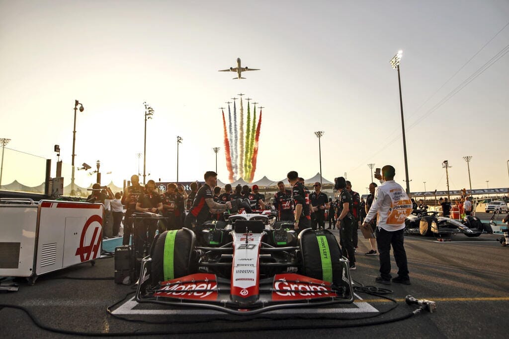 F1 car on track with jets overhead